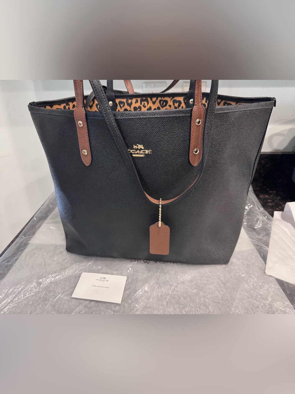 Coach Black Leather Tote with Brown Handles and Leopard-Print Interior